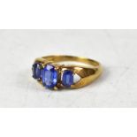 A 9ct yellow gold ring with three graduated claw set Tibetan kyanite, size O, approx 3g.