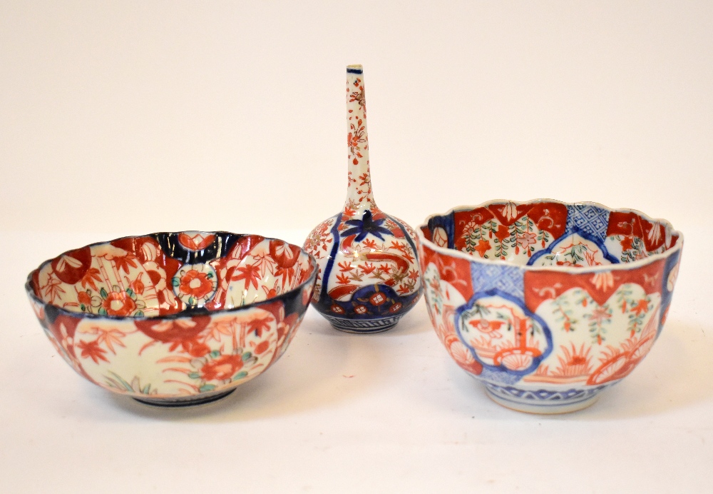 Three pieces of 19th century Imari pattern porcelain, comprising an onion-shaped single stem vase,