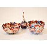 Three pieces of 19th century Imari pattern porcelain, comprising an onion-shaped single stem vase,