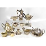 A large quantity of plated ware to include candlesticks, tea and coffee sets, various jugs,