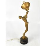 An Art Deco style gilded spelter table lamp in the form of a scantily-clad female,