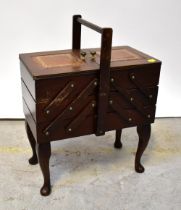 A reproduction mahogany cantilever sewing/workbox, with two small leather inset panels to the top,