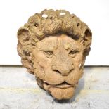 A terracotta and composite wall-hanging garden ornament in the form of a lion's head, height 42cm.