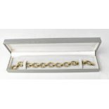 An unusual 9ct gold bracelet comprising eleven bark-textured naturalistic hoops,