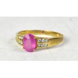 A 9ct gold ring with central protruding claw set oval pink sapphire,
