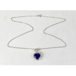 A 14ct white gold necklace pendant with heart-shaped claw set cut blue stone,
