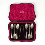 A cased set of six silver teaspoons and sugar tongs, bowls in the form of shells, Wakely & Wheeler,