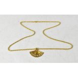 An 18ct gold necklace pendant in the form of a Spanish fan, inscribed 'Espagna' to the ends,