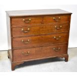 A George III oak chest of two small over three long drawers with swing handles,