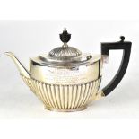 An Edwardian hallmarked silver teapot of Classical oval shape with fluted dome to lid and fluted