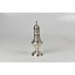 A George III hallmarked silver sugar caster with dome top and flame finial,