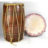 A large floorstanding drum with animal hide skins, a pair of smaller drums,