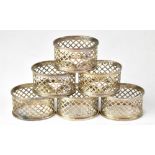 A set of six Elizabeth II hallmarked silver napkin rings of oval form,