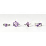 Four hallmarked silver amethyst and topaz rings,