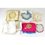 A quantity of vintage textiles and linen to include crochet doilies, beaded doilies, netting,
