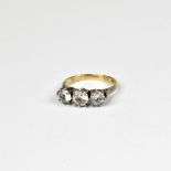A 9ct gold and silver fashion ring, with three claw set white stones in a silver top and shoulders,