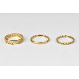 Three rings comprising a thin 9ct gold band, size N,