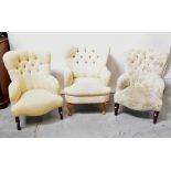 Three Victorian-style button back tub armchairs, each upholstered in a cream fabric,