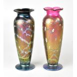 OKRA; a pair of lustre glass vases of tapering form, with flared rims, decorated with white flowers,