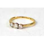 An 18ct yellow gold three-stone diamond ring,
