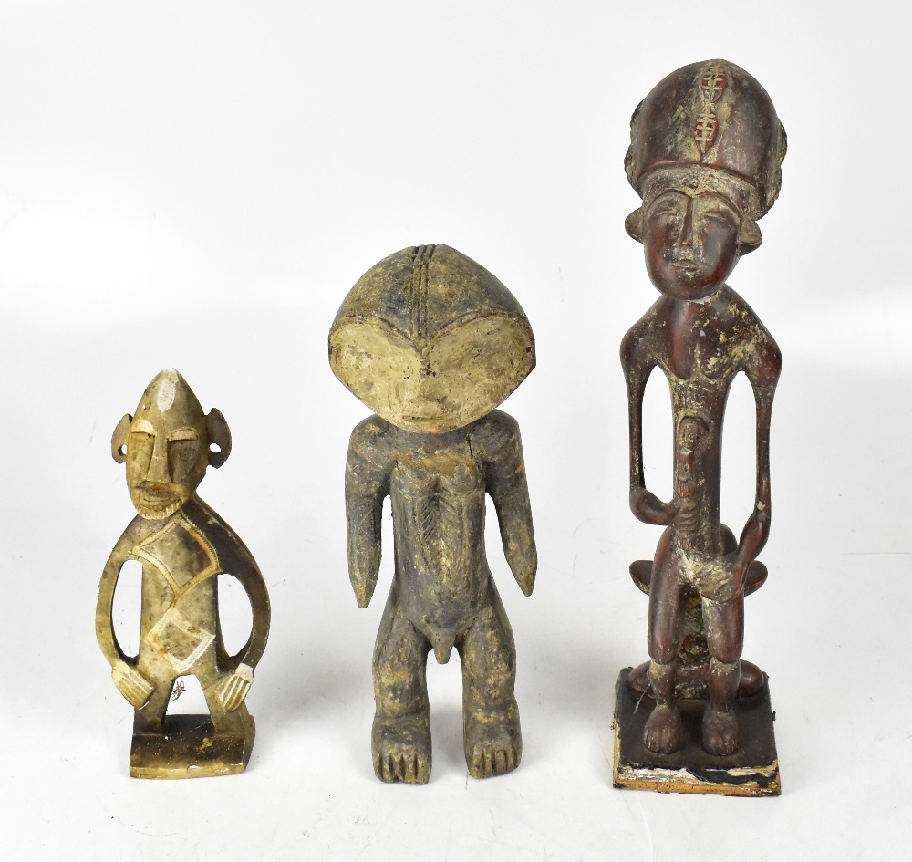 An African carved wooden tribal figure with traces of pigmentation, height 34cm,