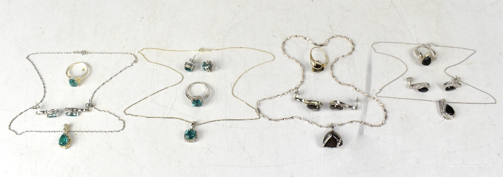 Four sterling silver and gem stone set jewellery sets,