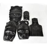 Various modern African carved wooden wall masks, various sizes and styles, the largest 38cm,