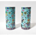 A pair of 20th century Chinese brush pots, both of cylindrical form and decorated with koi carp,