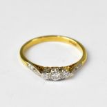 An 18ct gold ring set with central claw set diamond,