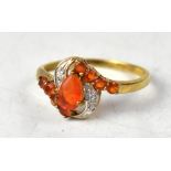 A 9ct yellow gold ring, set with central pear-shaped fire opal,