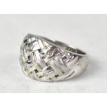 A 9ct white gold ring with a woven design set with eight tiny diamond chips, total approx 0.