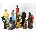 A large collection of painted plaster and resin decorative figures and busts.