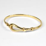 A ladies' 9ct gold bracelet with double banded body and large hoop-effect front,