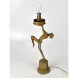 An Art Deco style gilded table lamp modelled as a nude female, with crackle-effect globular shade,
