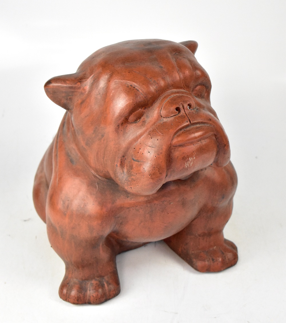 A large terracotta model of a seated English bulldog, height 38cm.