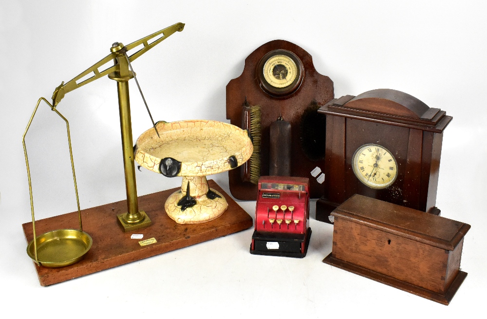 A group of collectors' items, including brass balance scales, clock, carved box, etc.