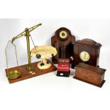A group of collectors' items, including brass balance scales, clock, carved box, etc.