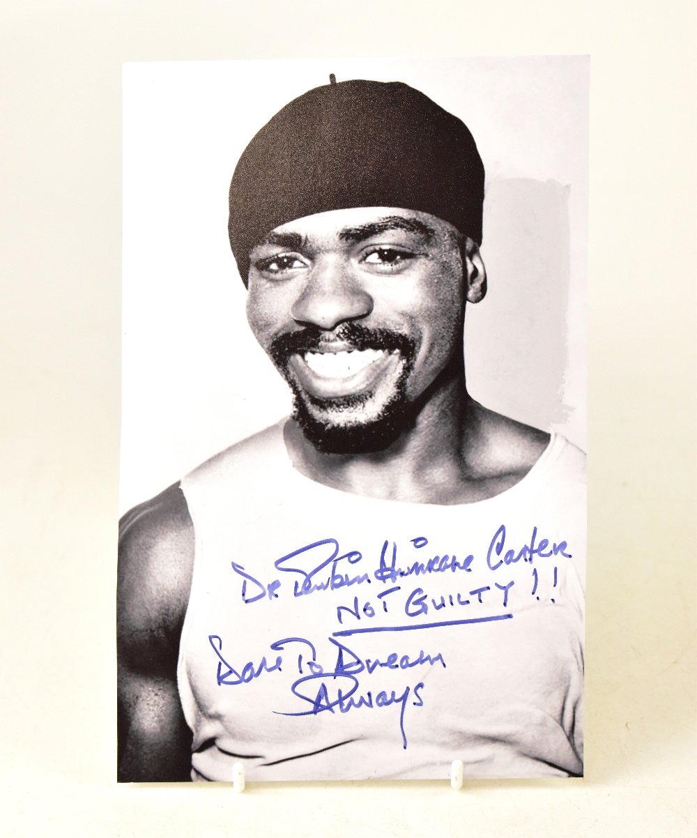 RUBIN 'HURRICANE' CARTER; a black and white photograph bearing the boxer's signature,