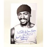 RUBIN 'HURRICANE' CARTER; a black and white photograph bearing the boxer's signature,
