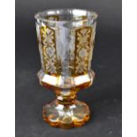 A 19th century Bohemian glass with amber overlay panels, with etched floral and scroll decoration,
