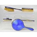 A George V hallmarked silver backed dressing table brush set,