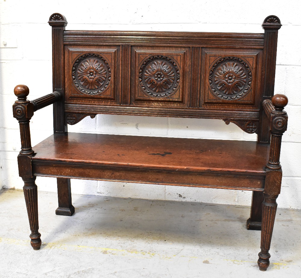 A Victorian carved oak bench, the back s