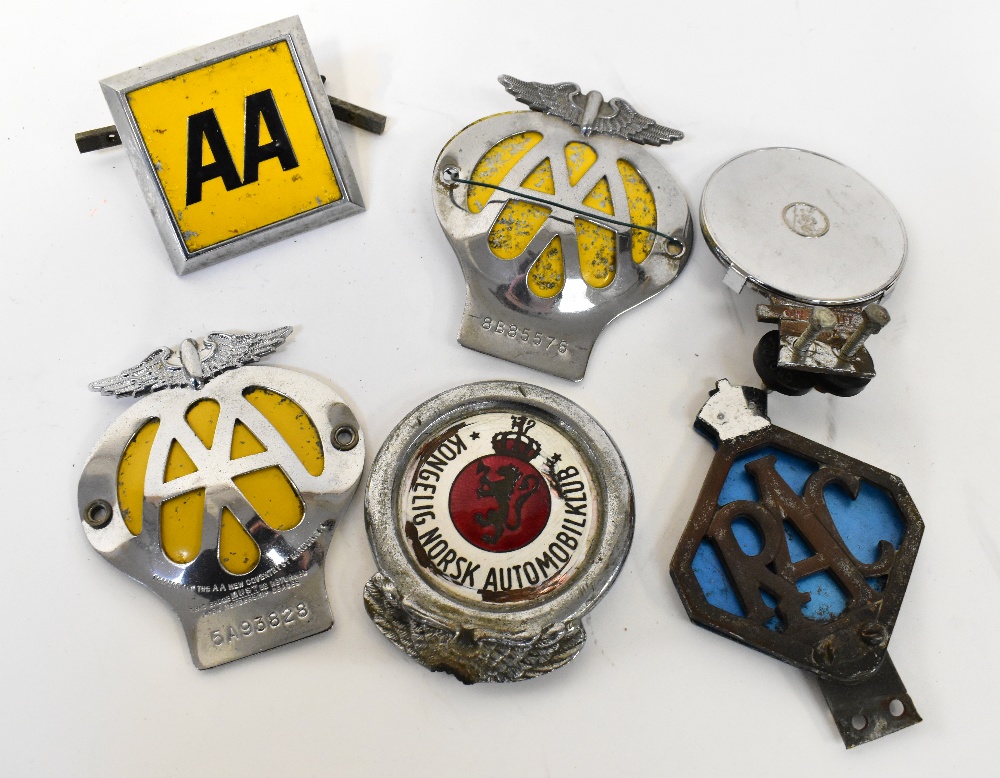 A quantity of various automobila badges