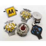 A quantity of various automobila badges