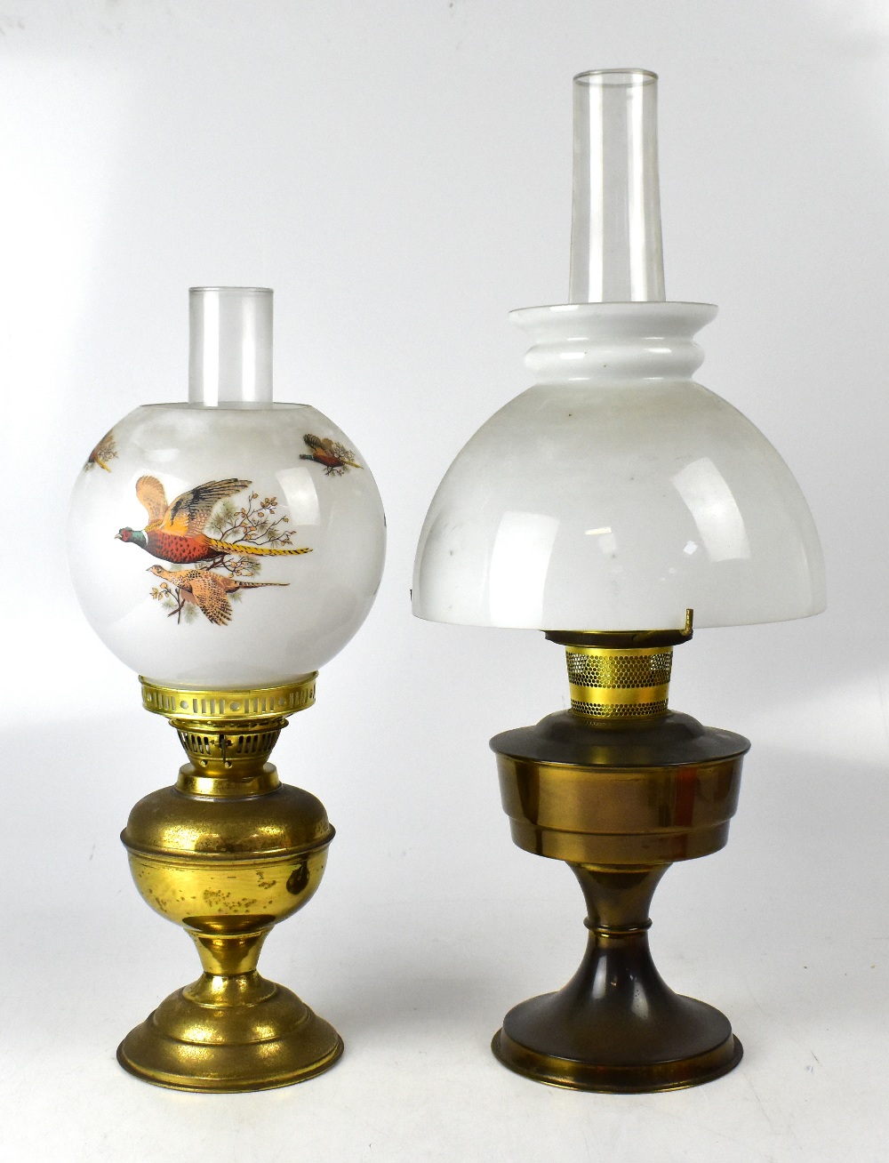 A brass oil lamp with opaque globular sh