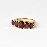 An antique 9ct gold garnet ring, the tab