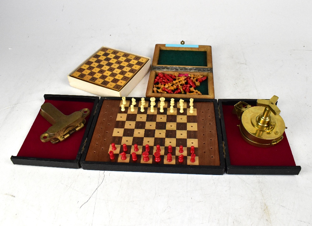 Three travelling chess sets, a spirit level with hinged cover, inscribed 'CSM',