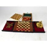 Three travelling chess sets, a spirit level with hinged cover, inscribed 'CSM',