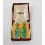 A pair of vintage jade-style earrings with carved tablet-style drops suspended under claw set round