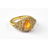A yellow metal dress ring set with centr